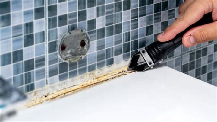 How do you get caulk residue off vinyl flooring?